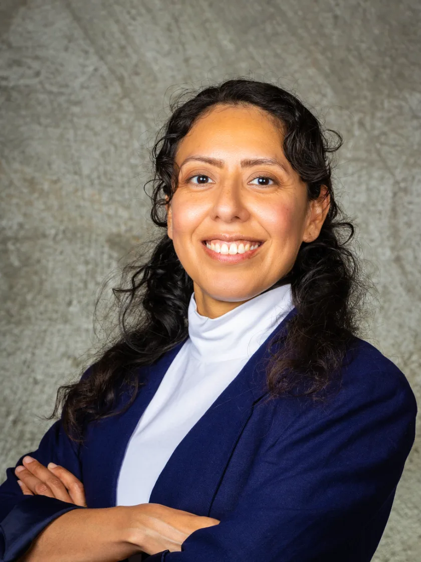 Zulma Y. Terrones in a navy blazer, arms crossed, smiling